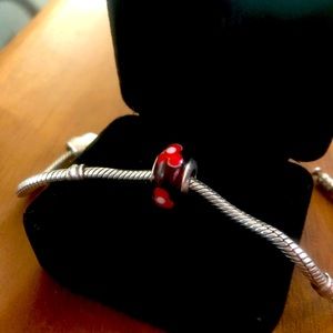 Retired Pandora “Red Flower” charm.
